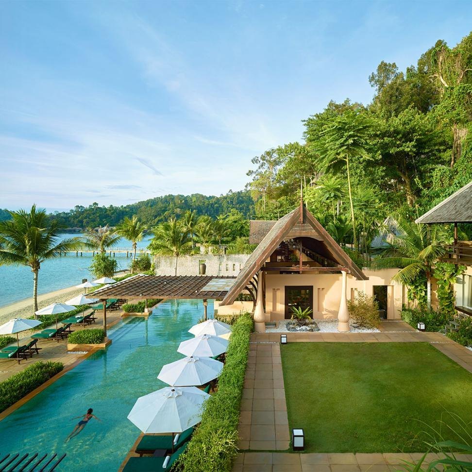 The resort pool and pavilion amid the rainforest, seen from above